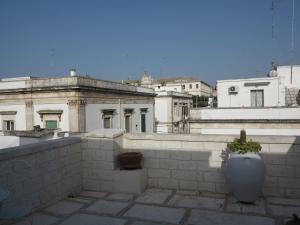 a view of a building with a planter on a balcony at Casa Nonna Stella in Martina Franca