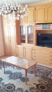 a living room with a coffee table and a tv at Apartment PER DAY in Vrbas