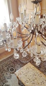 a silver chandelier with candles on a table at Apartment PER DAY in Vrbas