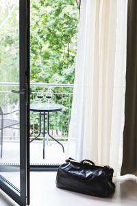 a black purse sitting on the floor in front of a door at Heritage Home Apartments in Budapest