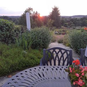 a bench in a garden with flowers on it at Brook Lodge in Glenties