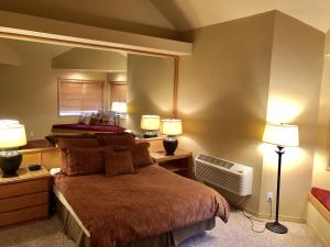 a bedroom with a bed with two lamps and a fan at River Ridge 416B condo in Bend