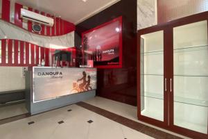 a lobby with a large screen in a building at RedDoorz Plus @ Rawamangun in Jakarta