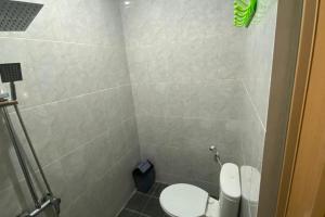 a small bathroom with a toilet and a shower at RedDoorz Plus @ Rawamangun in Jakarta