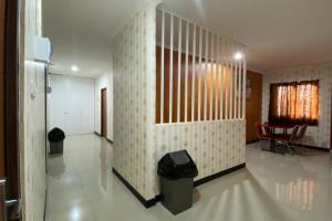 a hallway in a house with a trash can in it at RedDoorz Plus @ Rawamangun in Jakarta