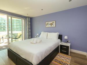 a bedroom with a large bed with purple walls at Sunrise Hill in Portland