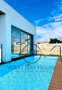 uma piscina em frente a uma villa em West Bay House em São Martinho do Porto