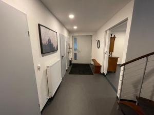 a hallway of a home with white walls and stairs at KIWE5 in Plauen