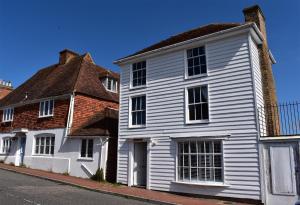 a white house next to a brick building at Matchbox in Winchelsea