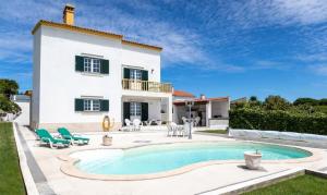a house with a swimming pool in front of it at NuvemCristina in Olho Marinho