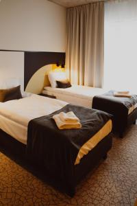 Katil atau katil-katil dalam bilik di Arche Hotel Piła