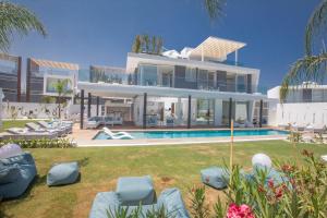 an image of a house with a swimming pool at Villa Olivine Pearl 3 in Protaras