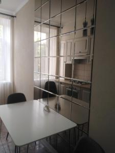 ムィコラーイウにある2-комнатная квартира на Соборнойのキッチン(白いテーブル、椅子付)