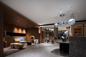 a lobby with a room filled with furniture and balloons at Arthur Hotel Canton Tower Guangzhou-广州塔骑士物语酒店 in Guangzhou
