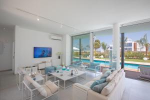 a living room with couches and a pool at Villa Olivine Pearl 3 in Protaras
