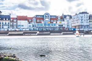 a group of buildings next to a body of water at Hotel Atlantic in Wimereux
