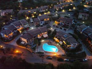 an aerial view of a house with a pool at Casa Cala Sardegna Budoni Residence con Piscina in Budoni