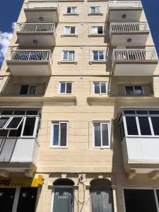 a tall building with balconies on the side of it at F7 Modern and Bright Apartment in Malta in Msida