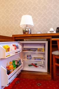 a refrigerator with its door open and a lamp on top at Eurohotel Swarzędz in Swarzędz