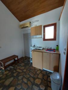 a small kitchen with a sink and a table at Beautiful house located on a hill with a spectacular sea view in Samos Island in Koumeika