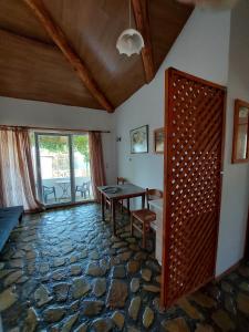 a living room with a table and a stone floor at Beautiful house located on a hill with a spectacular sea view in Samos Island in Koumeika