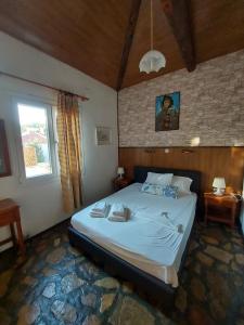 a bedroom with a large bed in a room at Beautiful house 800m from Koumeika, Samos in Koumeika