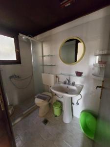a bathroom with a sink and a toilet and a mirror at Beautiful house 800m from Koumeika, Samos in Koumeika