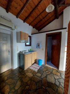 a kitchen with a sink and a stove in it at Beautiful house 800m from Koumeika, Samos in Koumeika