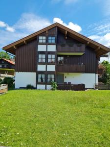 a house with a green lawn in front of it at Landhaus Eibelesee in Oberstaufen +57 photos