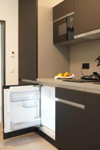 a kitchen with an open refrigerator with fruit in it at CAP1 Boardinghouse in Baesweiler