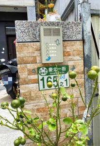 una señal en el lateral de un edificio con una planta en Forrest Cafe Villa en Jian