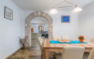 a dining room and living room with a table and chairs at Villa Mirabella in Umag