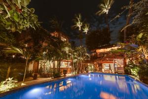 a large blue swimming pool in front of a building at Casa de Areia in Jericoacoara