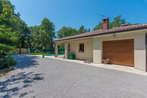 a garage with a brown garage door on a house at Villa Mirabella in Umag