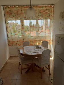 einen Tisch und Stühle in einer Küche mit Fenster in der Unterkunft APARTMENT SUNSHINE- center of Split in Split