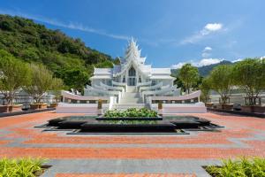 a white building with a fountain in a courtyard at InterContinental Phuket Resort by IHG in Kamala Beach