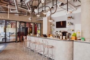 a bar in a restaurant with stools at Arche Hotel Piła in Piła