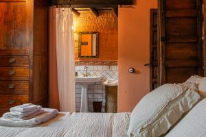a bedroom with a bed and a bathroom with a sink at TERRACEA in Hoyos