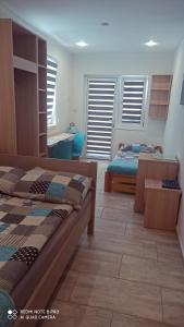 a bedroom with two beds and a table and chairs at Pensjonat Blue in Mielno