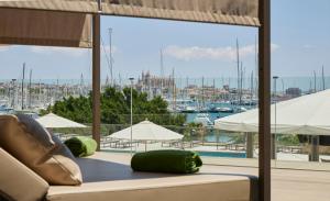 a living room with a couch and a view of a marina at Meliá Palma Marina in Palma de Mallorca