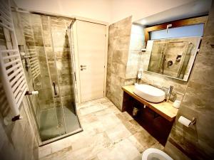 a bathroom with a shower and a sink and a toilet at B&B Il Vicolo in Caprarola