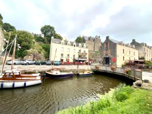 un grupo de barcos en un río frente a un edificio en Appartement avec balcon et vue sur port - wifi privé - au dessus du Restaurant le Yackams, en La Roche-Bernard