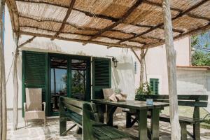 a patio with a wooden table and benches at Apartmaji Pajer in Koper