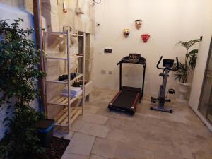 a room with a gym with a treadmill in it at Dimora Assuntina Martano in Martano