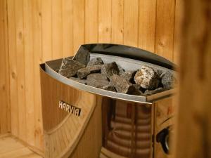 a container filled with rocks in a wooden wall at Halny Natura Tour in Karpacz