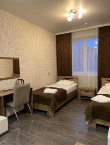 Uma cama ou camas num quarto em отель VICTORIA CITY