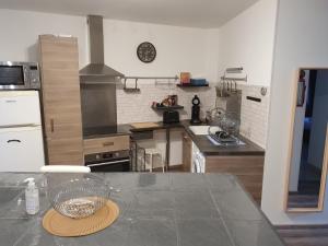 a kitchen with a table with a bowl on the counter at Le petit provencal in Espeluche