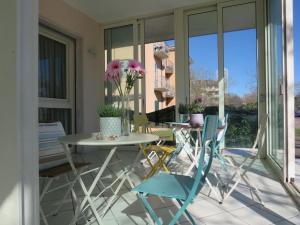 a patio with a table and chairs on a patio at Hotel Primula in Cesenatico