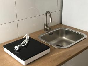 a laptop on a counter next to a sink at affittacamere alloggio olivo Empoli a pochi passi dalla stazione in Empoli +34 photos