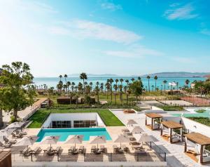 an aerial view of a resort with a pool and chairs at Radisson Collection Hotel, Bodrum in Akyarlar